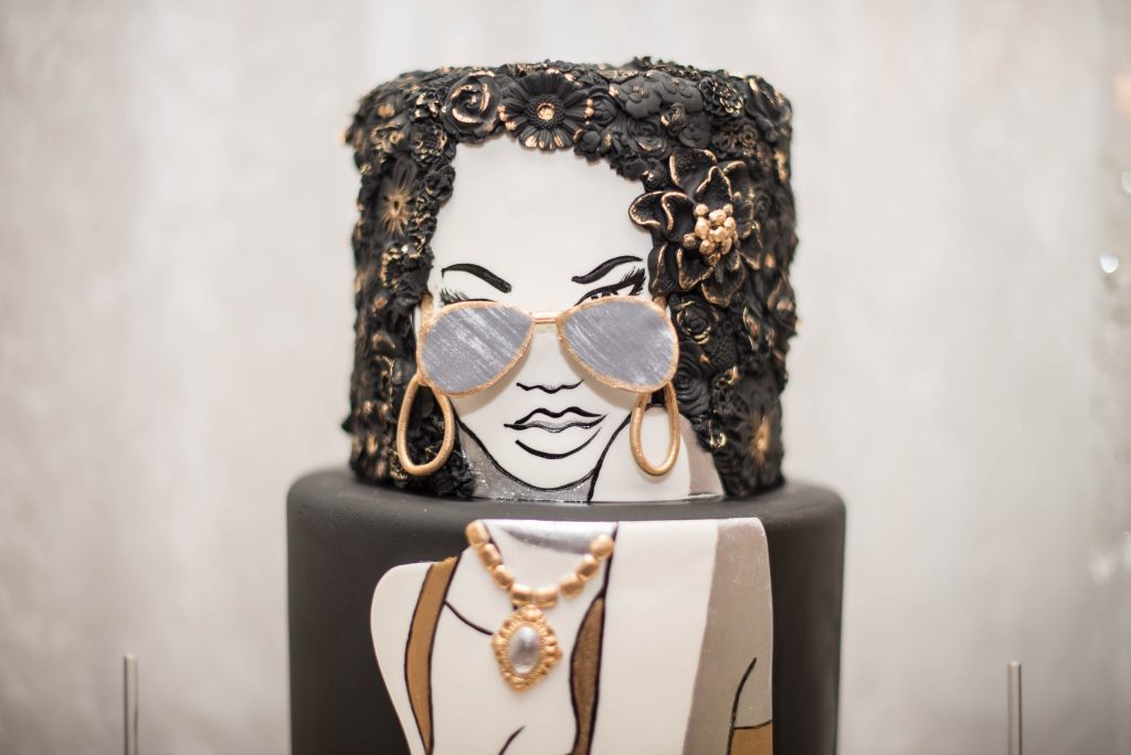 closure up face cake with sugar sunglasses and bas relief hair